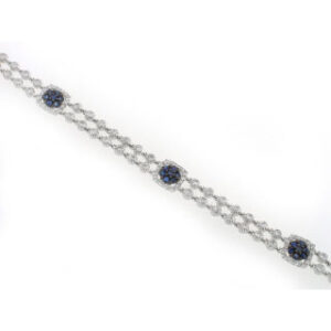 18k White Gold tennis prong set round brilliant Diamonds and oval cut blue sapphire bracelet .